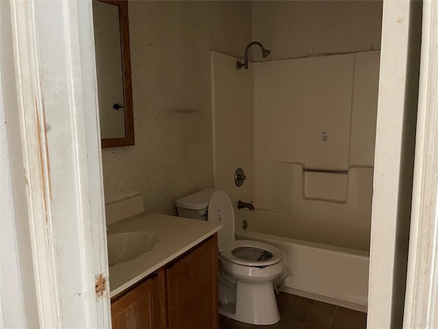 full bath with shower / washtub combination, toilet, vanity, tile patterned flooring, and wallpapered walls