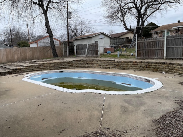 view of swimming pool with a fenced backyard and a fenced in pool