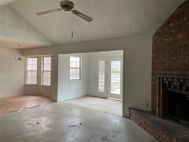 unfurnished living room with lofted ceiling, a textured ceiling, and a fireplace