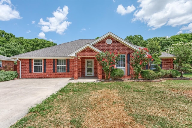 ranch-style house with brick siding, roof with shingles, and a front yard