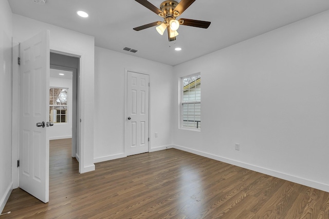 unfurnished bedroom with dark wood-style flooring, recessed lighting, visible vents, and baseboards