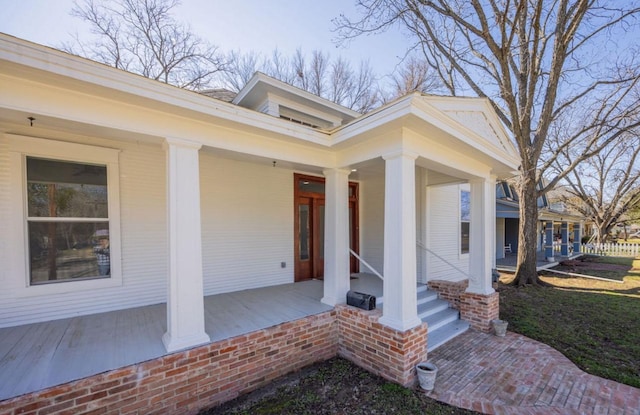 view of exterior entry with a porch