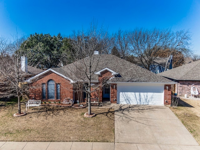 ranch-style house featuring a front lawn, concrete driveway, brick siding, and an attached garage