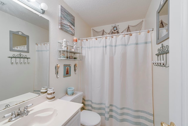 bathroom with toilet, a shower with curtain, a textured ceiling, and vanity