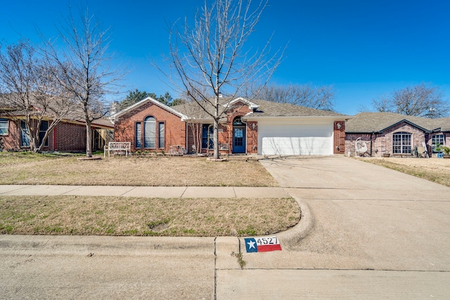 ranch-style house with concrete driveway, brick siding, a front lawn, and an attached garage