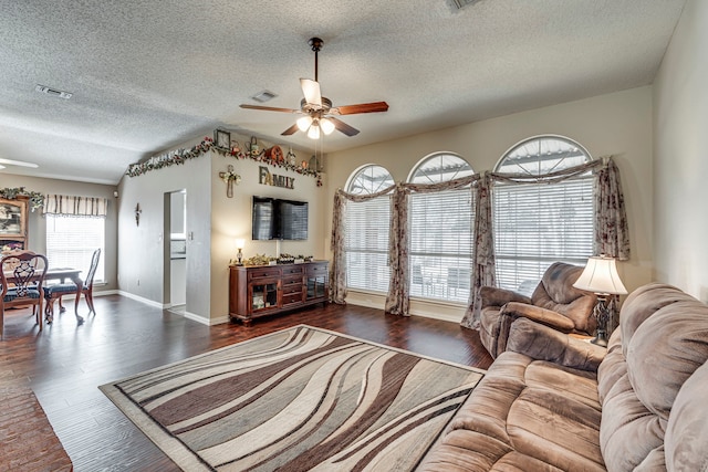 living room featuring visible vents, ceiling fan, and wood finished floors