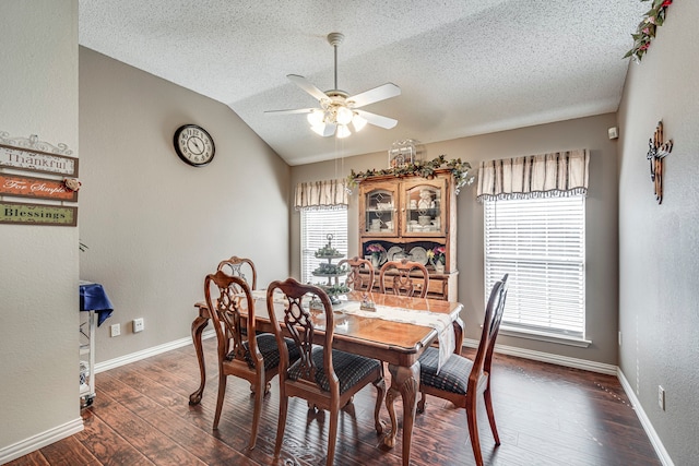 dining area featuring a ceiling fan, lofted ceiling, dark wood finished floors, and baseboards