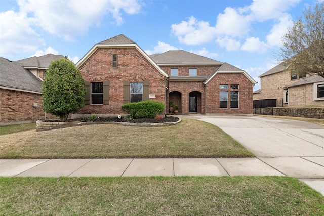 6502 Lakecrest Dr, Sachse, TX 75048 - traditional-style house featuring brick siding, a front lawn, and driveway