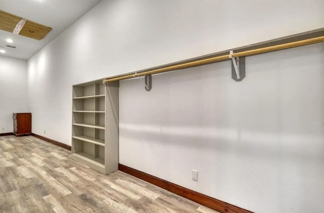 walk in closet featuring wood finished floors