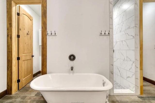 full bath with a soaking tub, baseboards, a shower, and wood finished floors