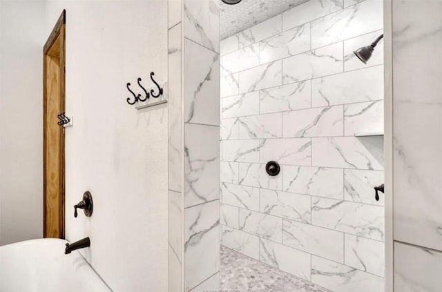 bathroom with a tile shower and a freestanding bath