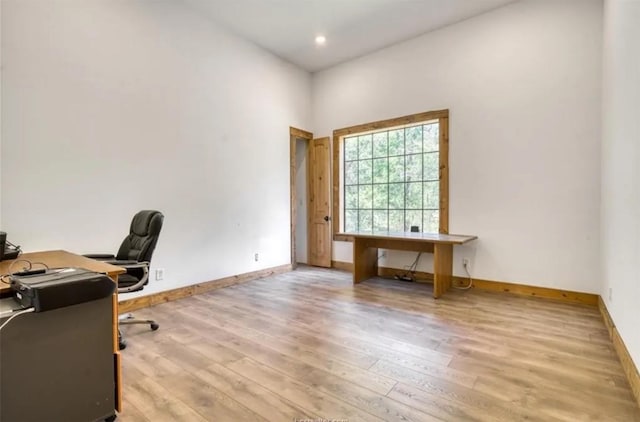 home office featuring baseboards, wood finished floors, and recessed lighting