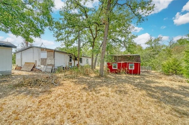 exterior space featuring an outdoor structure and a storage unit