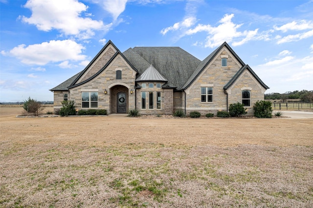 french provincial home with a standing seam roof, a front lawn, and metal roof