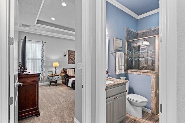 bathroom with visible vents, toilet, ornamental molding, a stall shower, and vanity