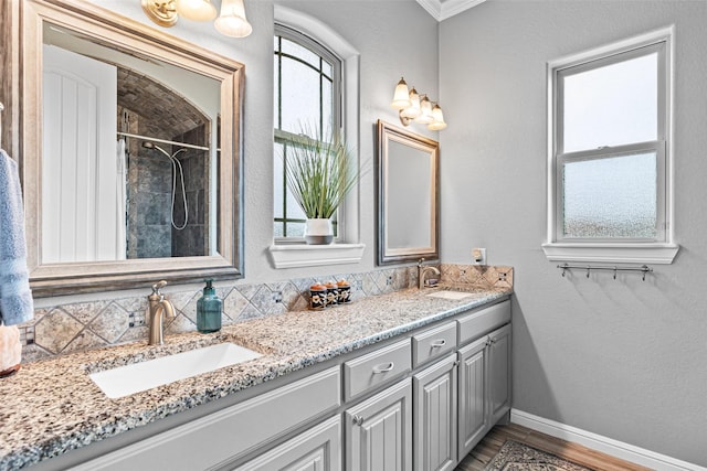 bathroom with double vanity, plenty of natural light, and a sink