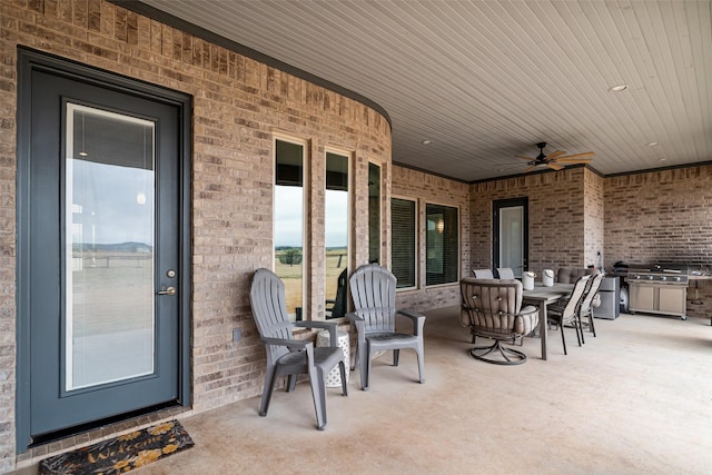 view of patio / terrace featuring ceiling fan, area for grilling, and outdoor dining space