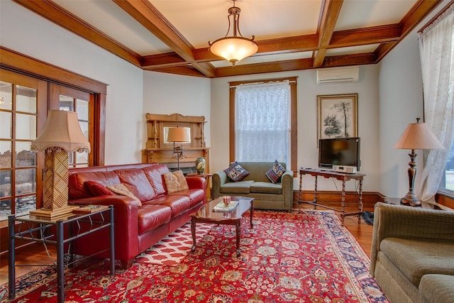 living area with baseboards, coffered ceiling, beamed ceiling, wood finished floors, and an AC wall unit