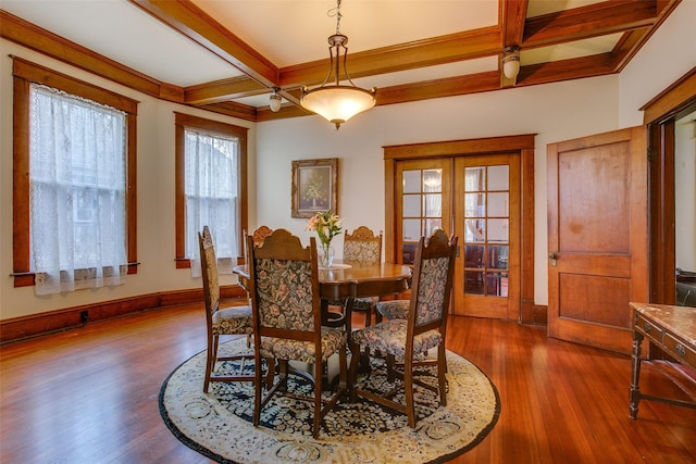 dining space with french doors, coffered ceiling, and wood finished floors