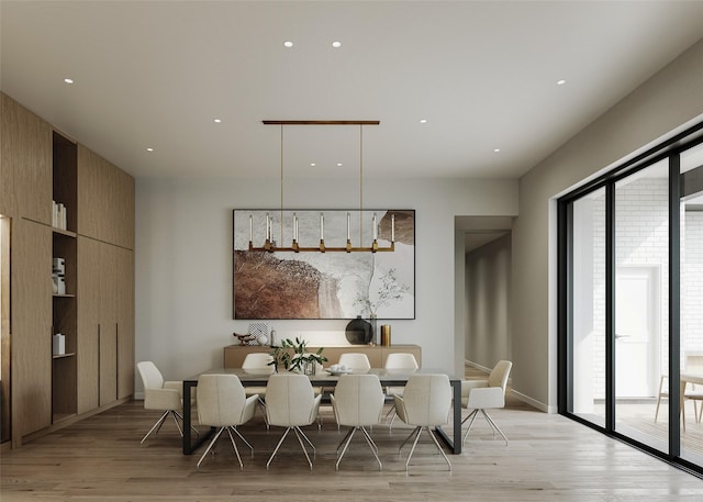 dining room with recessed lighting and light wood finished floors