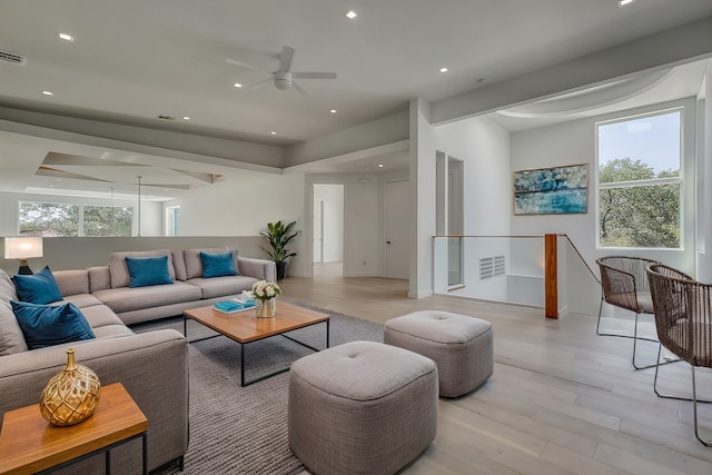 living area featuring plenty of natural light, visible vents, light wood-style flooring, and recessed lighting