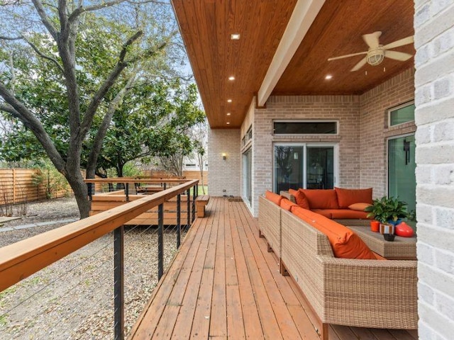 deck featuring ceiling fan, outdoor lounge area, and fence