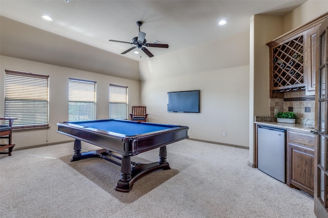 game room with recessed lighting, light carpet, vaulted ceiling, a bar, and baseboards