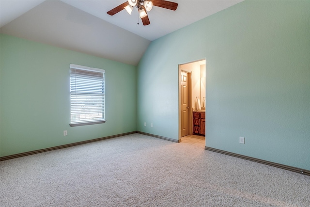 unfurnished room featuring a ceiling fan, carpet flooring, vaulted ceiling, and baseboards