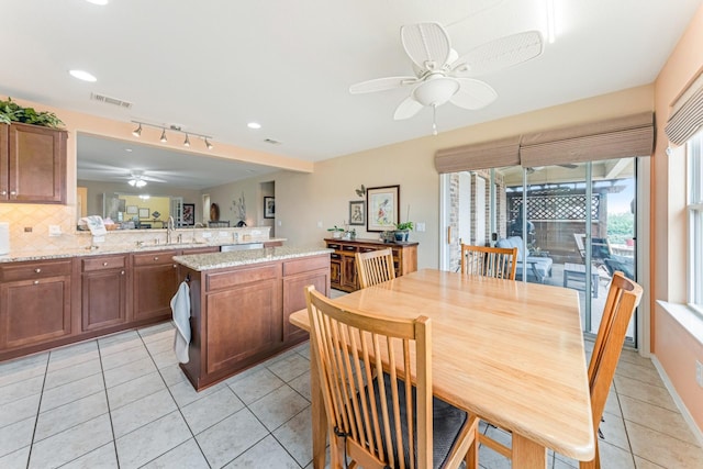 dining room with light tile patterned floors, visible vents, and a ceiling fan