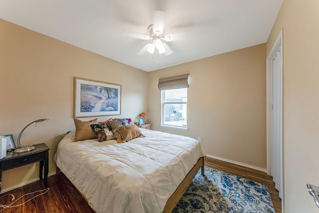 bedroom with wood finished floors, a ceiling fan, and baseboards