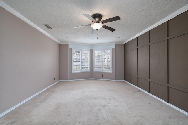 interior space featuring visible vents, a ceiling fan, light colored carpet, a textured ceiling, and crown molding