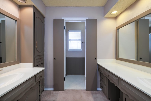 full bathroom featuring two vanities and a sink