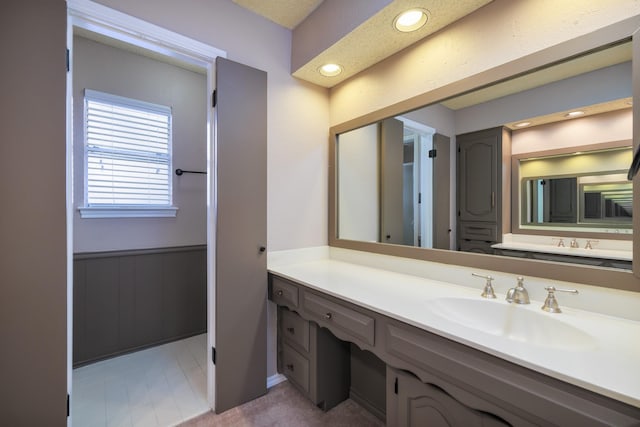 bathroom featuring wainscoting, vanity, and recessed lighting