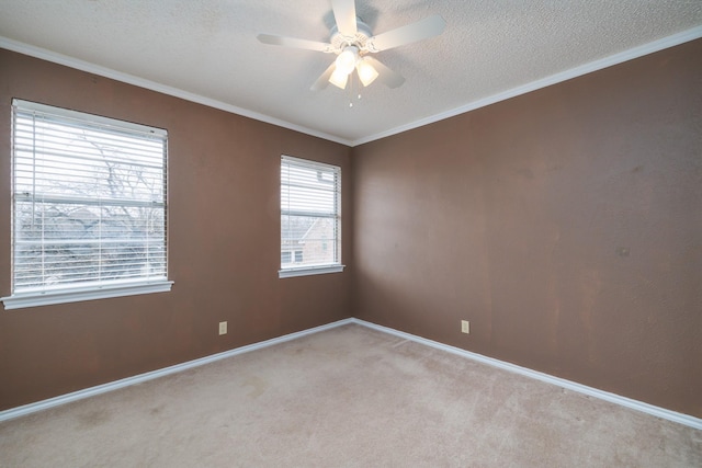 unfurnished room featuring a textured ceiling, ceiling fan, light colored carpet, baseboards, and ornamental molding