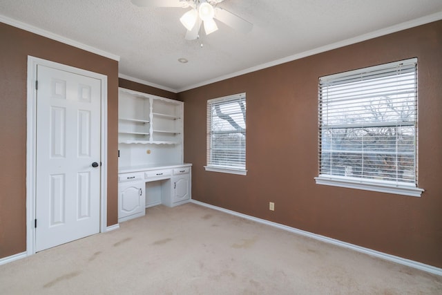 unfurnished bedroom featuring light carpet, a textured ceiling, and crown molding