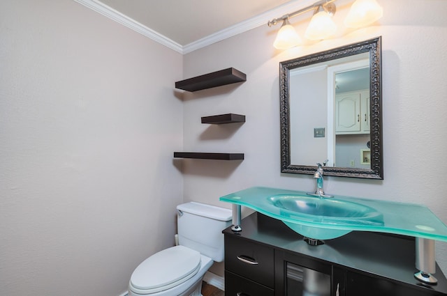 bathroom featuring vanity, toilet, and crown molding