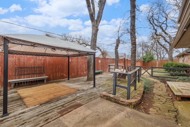 view of yard featuring a fenced backyard, a wooden deck, and a gazebo