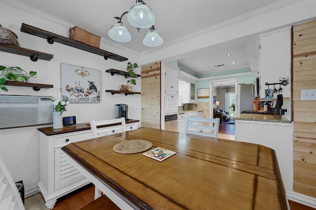 dining area featuring recessed lighting and crown molding