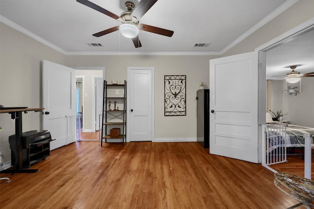 bedroom featuring ornamental molding, visible vents, and light wood finished floors