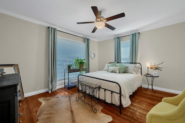 bedroom featuring baseboards, ornamental molding, ceiling fan, and wood finished floors