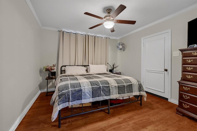 bedroom with ceiling fan, ornamental molding, wood finished floors, and baseboards