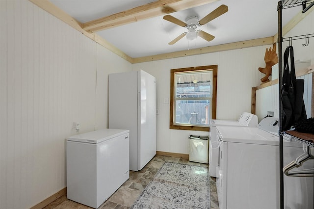 laundry area featuring a ceiling fan, stone finish flooring, laundry area, independent washer and dryer, and baseboards