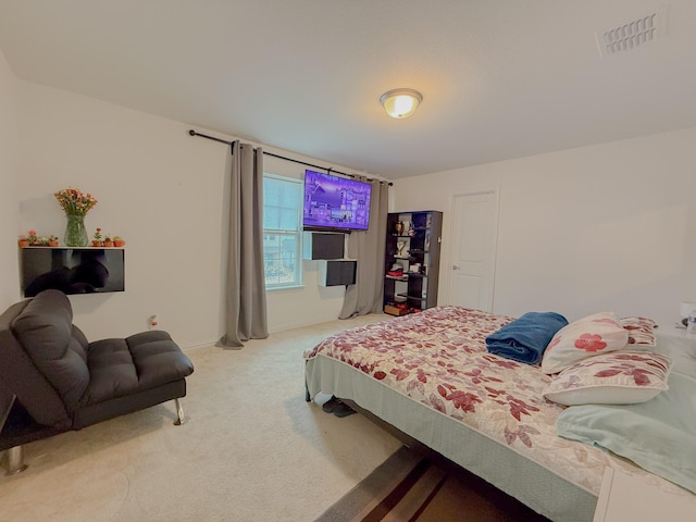 carpeted bedroom featuring visible vents and baseboards