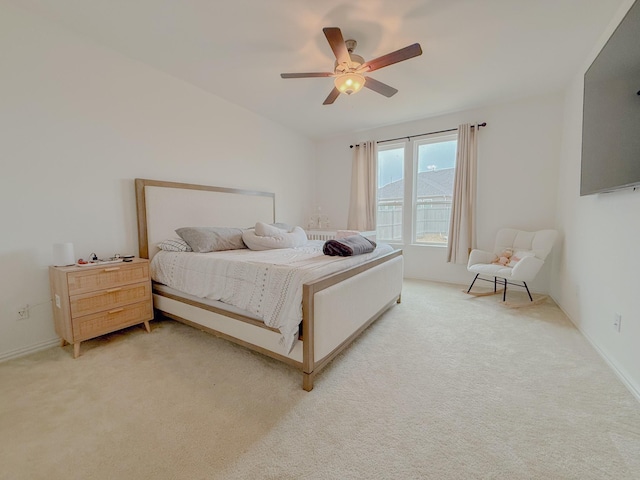 bedroom with ceiling fan and light colored carpet