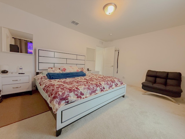 carpeted bedroom featuring visible vents