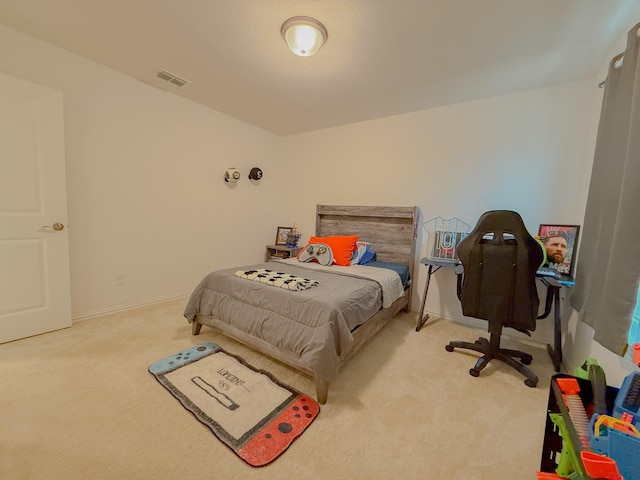 carpeted bedroom featuring baseboards and visible vents