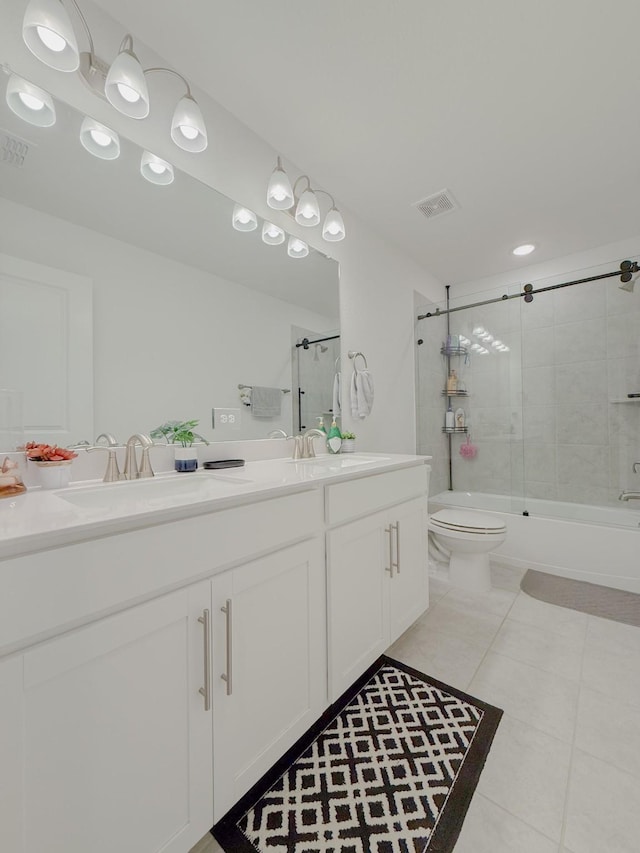 full bathroom with visible vents, a sink, toilet, and double vanity