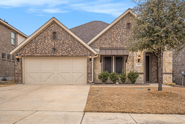 view of front of home with driveway, a standing seam roof, a shingled roof, a garage, and brick siding