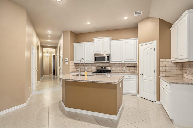 kitchen featuring visible vents, white cabinets, appliances with stainless steel finishes, and a sink