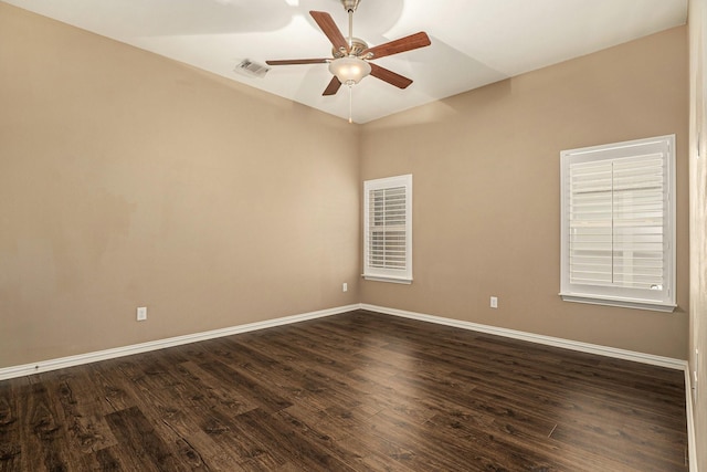 empty room with visible vents, baseboards, and dark wood-style flooring